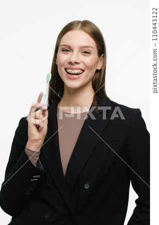 Young beautiful woman with toothbrush isolated on white background Young beautiful woman with toothbrush isolated on white background 110443122