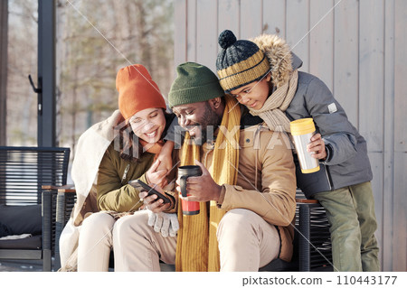 Looking through photos in mobile phone Looking through photos in mobile phone 110443177