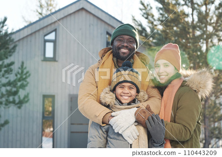 Happy family in front of country house Happy family in front of country house 110443209