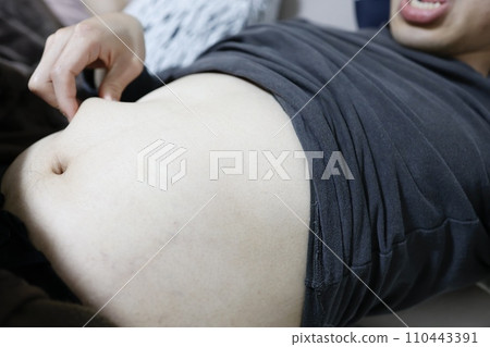 An adult man is picking belly fat An adult man is picking belly fat 110443391
