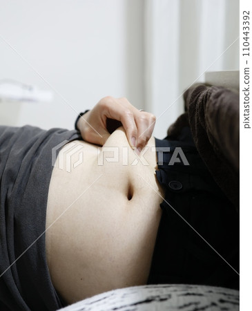 An adult man is picking belly fat An adult man is picking belly fat 110443392