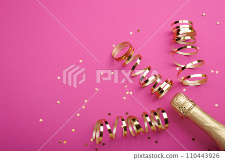 Champagne bottle with confetti stars on color background, space for text 110443926