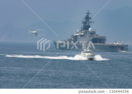 A Japan Coast Guard patrol boat and helicopter pass by a Maritime Self-Defense Force destroyer. A Japan Coast Guard patrol boat and helicopter pass by a Maritime Self-Defense Force destroyer. 110444356