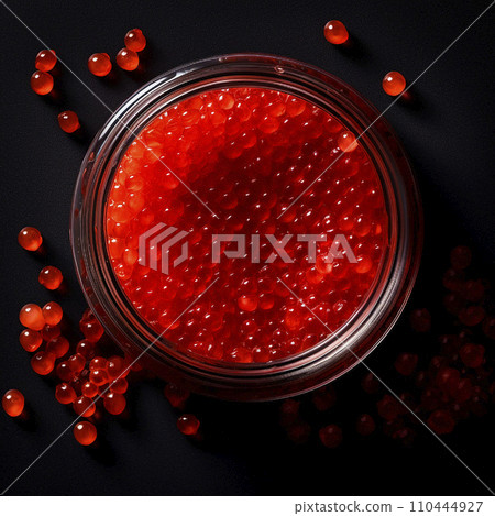 Red caviar, a jar with fresh appetizing, tasty caviar on a black background, top view, flatley, for advertising and design of fish stores 110444927
