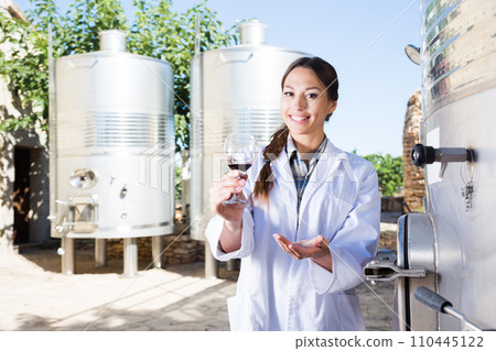 Professional checks the wine at factory in France Professional checks the wine at factory in France 110445122