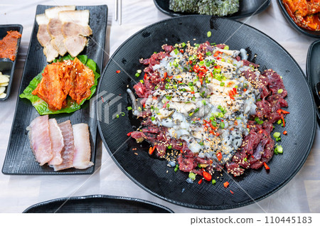 Korean food. Sliced raw beef and live octopus Korean food. Sliced raw beef and live octopus 110445183