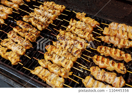 Marinated shashlik preparing on a barbecue grill over charcoal. 110445356