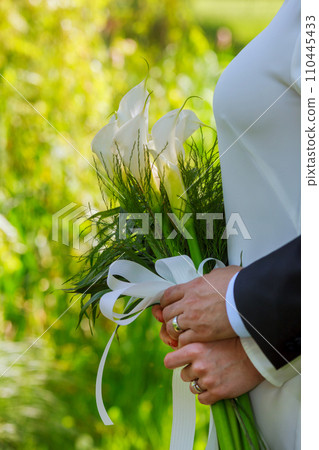 bride and groom holding a bouquet of Kala 110445433
