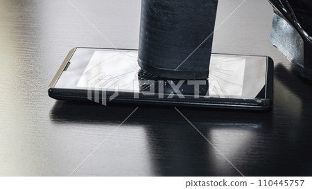 Broken screen telephone with heel shoes closeup 110445757