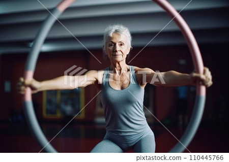 mature elderly woman, pensioner, smiling happily, does lifestyle gymnastics for health in gym. mature elderly woman, pensioner, smiling happily, does lifestyle gymnastics for health in gym. 110445766