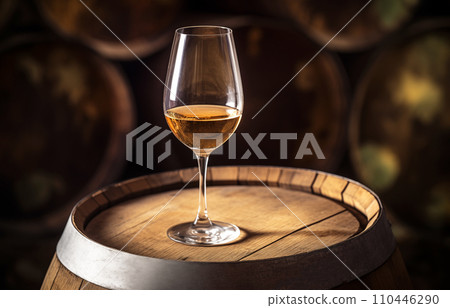 Wine Glass with Chardonnay Grapevine tasting. Vini Degustation in wine cellar with Wine barrels. Wine Glass with Chardonnay Grapevine tasting. Vini Degustation in wine cellar with Wine barrels. 110446290