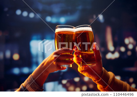 Two hands holding big mug of lager unfiltered foamy beer and clinking. Two friends sitting in bar and drinking alcohol drinks. Two hands holding big mug of lager unfiltered foamy beer and clinking. Two friends sitting in bar and drinking alcohol drinks. 110446496