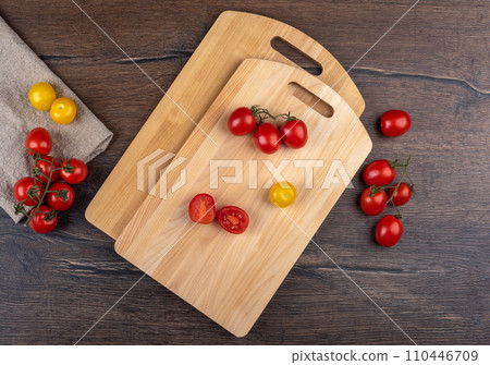 Two cutting boards on a wooden background with tomatoes. Two cutting boards on a wooden background with tomatoes. 110446709