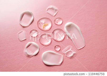 Gel, serum and a cream on a pink background. 110446750