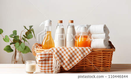 AI-generated content. Various detergents for washing and cleaning, colored towels in wicker basket, on light tabletop with green plants 110446844