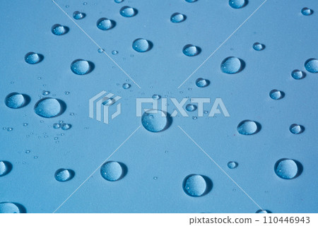 Water drops on blue background. Cosmetic drawing with transparent drops of micellar water, serum, collagen. Beauty background, spa concept Water drops on blue background. Cosmetic drawing with transparent drops of micellar water, serum, collagen. Beauty background, spa concept 110446943