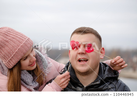 Young beautiful woman with red sweets on a stick in hands 110446945