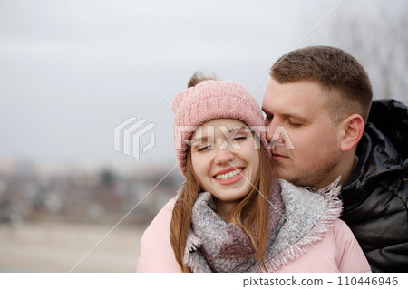 Portrait of a young happy couple outside on a walk Portrait of a young happy couple outside on a walk 110446946
