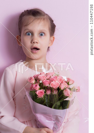 A cute little girl in a pink dress holds a bouquet of pink roses A cute little girl in a pink dress holds a bouquet of pink roses 110447198