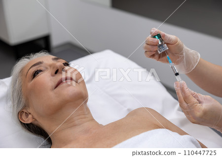 Female patient having beauty injections at beauty clinic 110447725