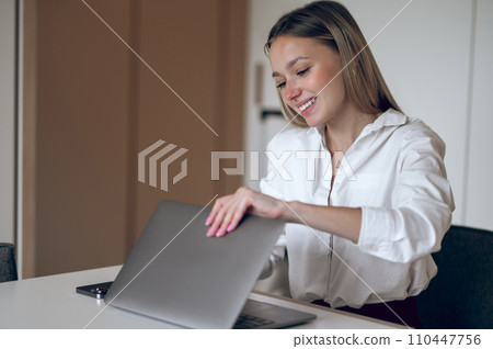 Long-haired young business woman at her working place 110447756