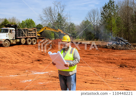 Build engineer inspects construction of new home using construction blueprint plan during construction 110448221