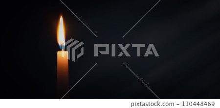 Candle burning in darkness over black background Candle burning in darkness over black background 110448469