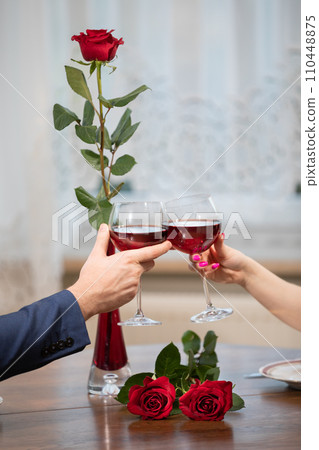 A toast raised over a table full of flowers. 110448875
