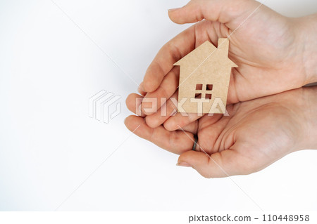 hands holding paper house, family home, homeless housing, mortgage crisis and home protecting insurance concept, foster home care, family day care, social distancing. 110448958
