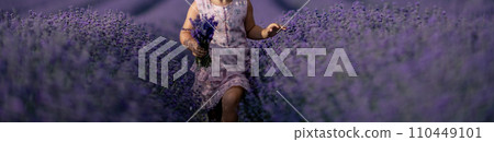 Lavender field girl banner. happy girl in pink dress runs through a lilac field of lavender. Aromatherapy concept, lavender oil, photo session in lavender 110449101