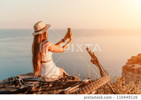 Selfie woman in cap and tank top making selfie shot mobile phone post photo social network outdoors on sea background beach people vacation lifestyle travel concept. Selfie woman in cap and tank top making selfie shot mobile phone post photo social network outdoors on sea background beach people vacation lifestyle travel concept. 110449126