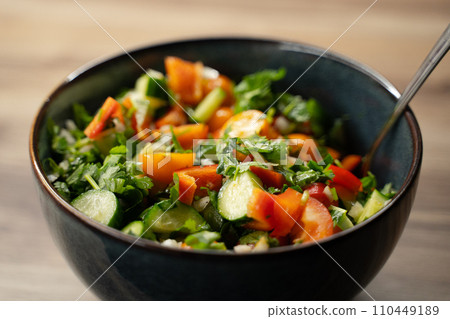 In fresh delicious salad vegetables Close-up stirring with spoon In fresh delicious salad vegetables Close-up stirring with spoon 110449189