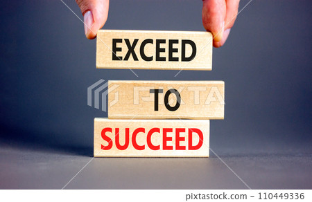 Exceed to succeed symbol. Concept words Exceed to succeed on beautiful wooden blocks. Beautiful grey table grey background. Businessman hand. Business and exceed to succeed concept. Copy space. 110449336