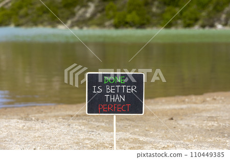 Done is better than perfect symbol. Concept words Done is better than perfect on beautiful blackboard. Beautiful mountain lake background. Business, done is better than perfect concept. Copy space. 110449385