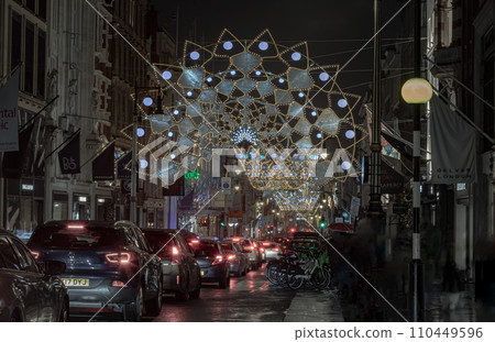 Christmas crowns decoration led lights display. Dramatic view of the traditional Christmas decoration lights hanging above Bond street during dusk. 110449596