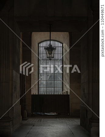Sunshine Through arched window alcove and lamp to The Louvre courtyards. 110449671