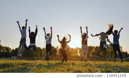Group of five happy friends jumps at sunset time on background mountains. Group of five happy friends jumps at sunset time on background mountains. 110451229