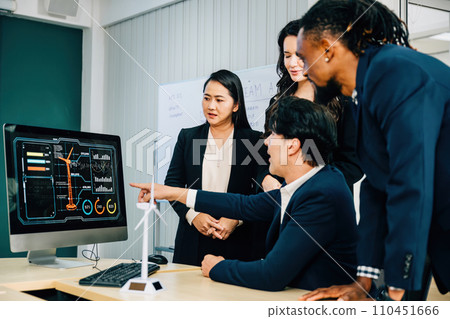 Colleagues with diverse skills and backgrounds convene around a desktop computer for a productive meeting. Their teamwork, discussion, and leadership contribute to successful marketing strategies. Colleagues with diverse skills and backgrounds convene around a desktop computer for a productive meeting. Their teamwork, discussion, and leadership contribute to successful marketing strategies. 110451666