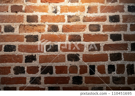 Grungy dark brick wall with spotlight, background texture Grungy dark brick wall with spotlight, background texture 110451695