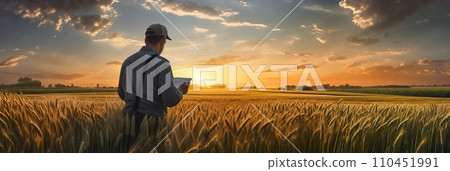 A male agronomist farmer with a digital tablet in the hands studies the quality of wheat harvest, modern technologies in agroindustry, banner A male agronomist farmer with a digital tablet in the hands studies the quality of wheat harvest, modern technologies in agroindustry, banner 110451991