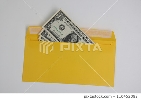 banknotes in a yellow envelope. open envelope with banknotes on a light background. envelope with banknotes. close up of an envelope with cash. international currency banknote. Euro dollars rubles. 110452082