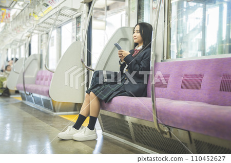 High school girl commuting to school by train High school girl commuting to school by train 110452627