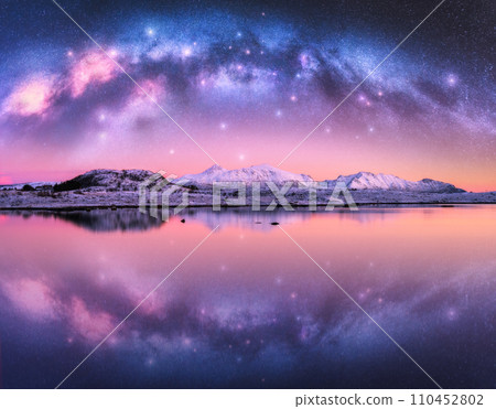 Milky Way arch over snowy mountains and sea coast at winter night Milky Way arch over snowy mountains and sea coast at winter night 110452802