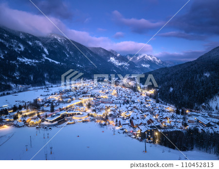 Aerial view of beautiful alpine village at cold winter night Aerial view of beautiful alpine village at cold winter night 110452813