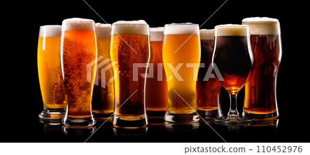 Set of Beer glasses on a black background. Mugs with drink like Ipa, Pale Ale, Pilsner, Porter or Stout 110452976
