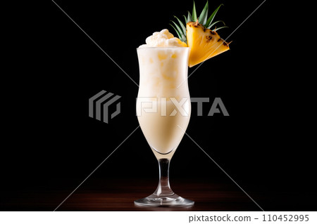 The classic Pina Colada with pineapple, coconut and creamy white top presented in a chilled glass with straw 110452995