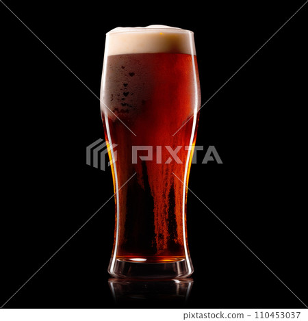 Beer in a tall glass on a dark black background. Mugs with drink like Ipa, Pale Ale, Pilsner, Porter or Stout Beer in a tall glass on a dark black background. Mugs with drink like Ipa, Pale Ale, Pilsner, Porter or Stout 110453037