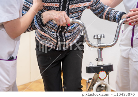 Nurse assists her senior patient. Recuperation for elderly, seniors care, nursing home. 110453070