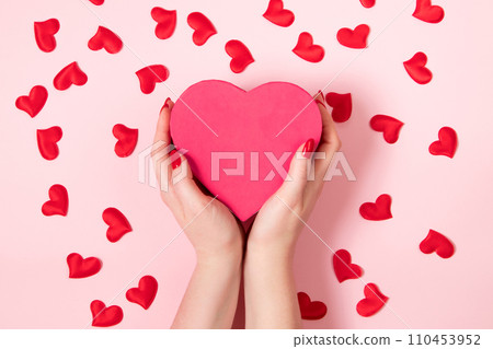Female hands are holding large pink heart. Valentine's day concept, place for text Female hands are holding large pink heart. Valentine's day concept, place for text 110453952