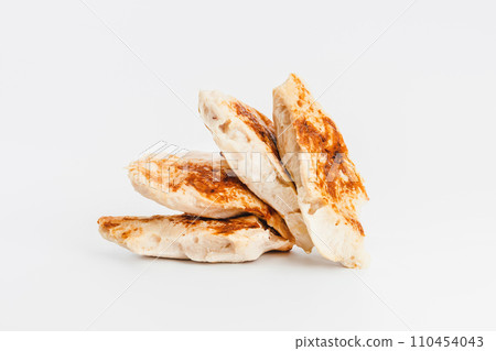 Fast food. Chicken fillets fried until half cooked, semi-finished product on a white background. Quick cooking at home. Copy space.Fast cooking.Fast homemade food. 110454043